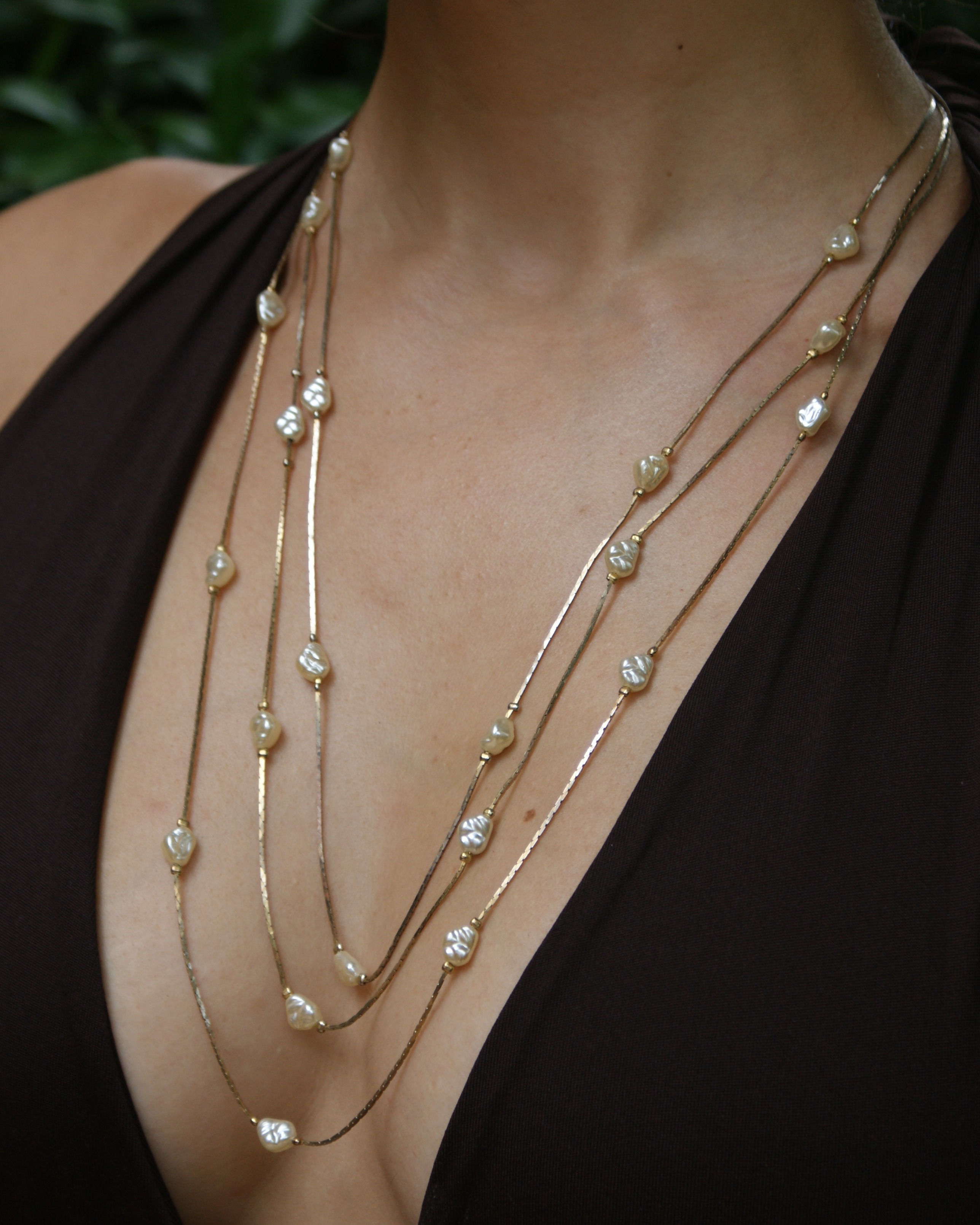 Golden multi-strand necklace with baroque pearls