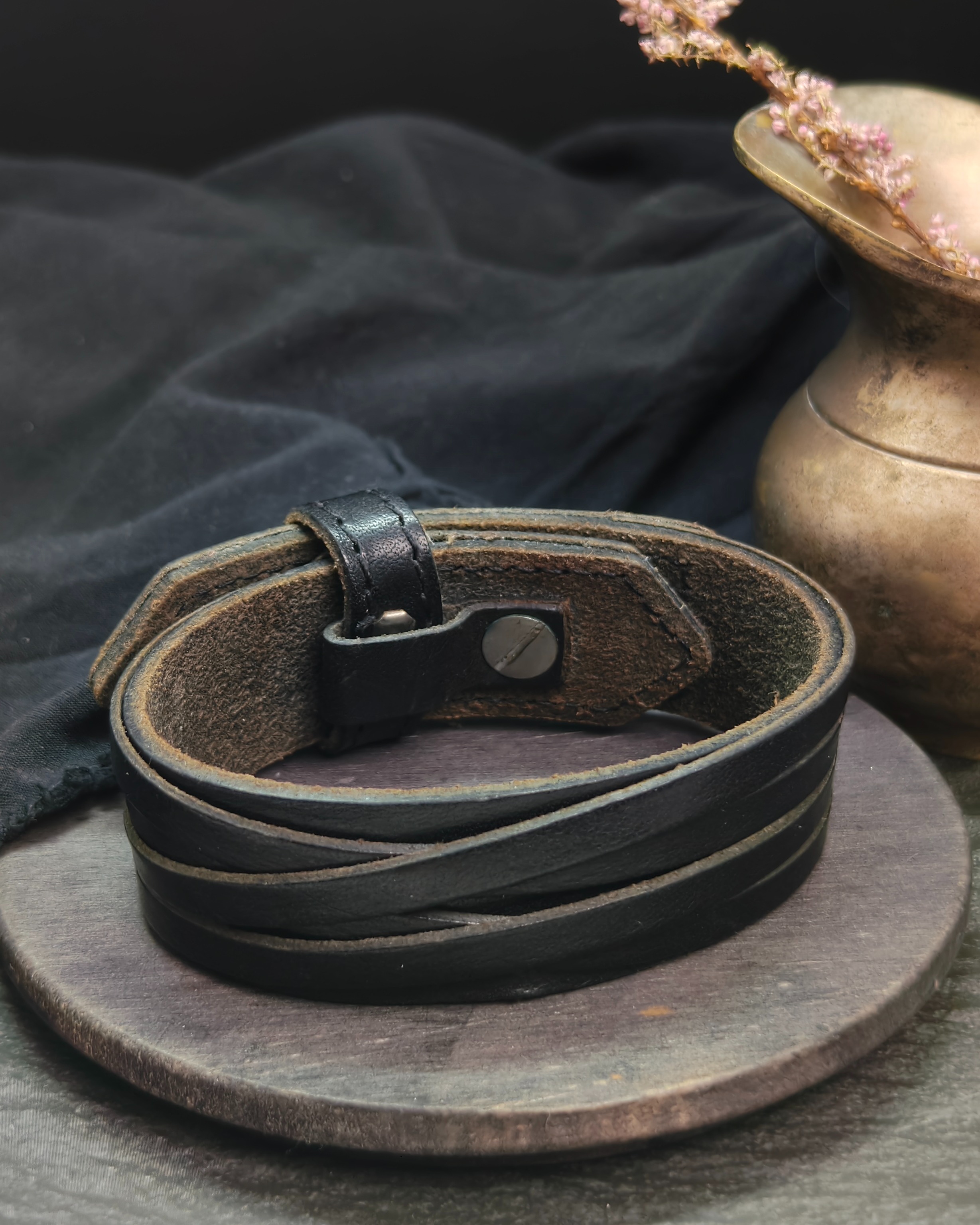 Wide black bracelet with leather straps