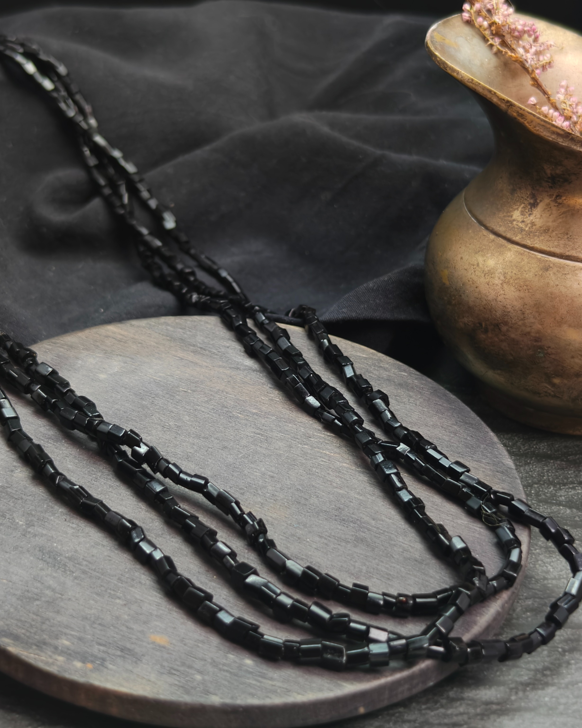Long necklace with faceted black glass beads