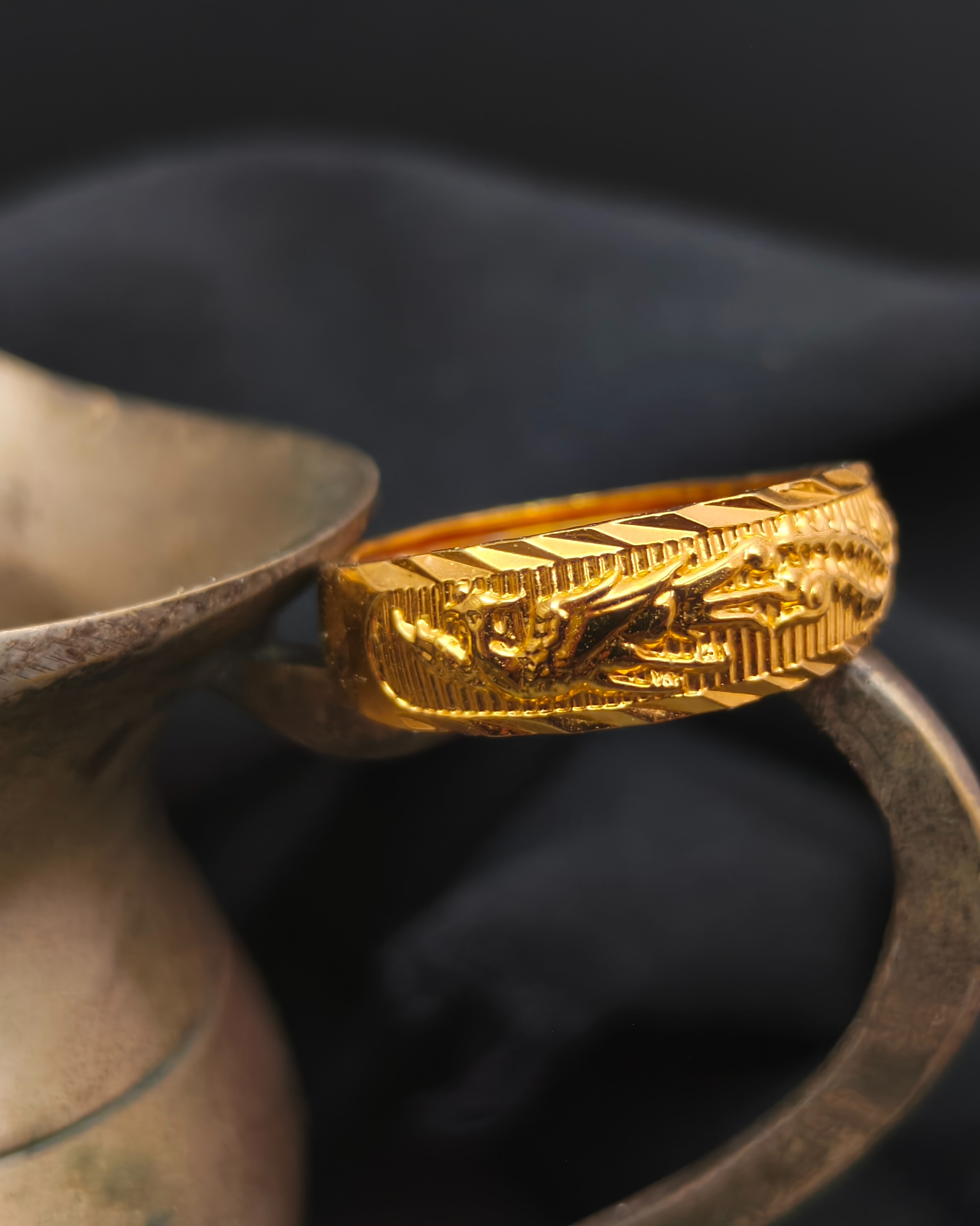 Adjustable golden-tone ring with a Phoenix in relief